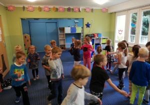 Dzieci poruszają się po sali w rytm muzyki