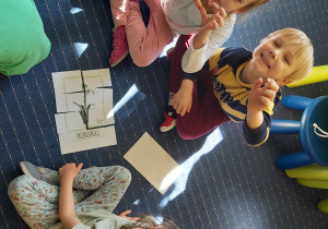 Dzieci z grupy II układają wiosenne puzzle.